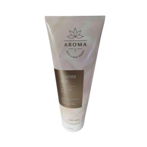 May include: A tube of Bath & Body Works Aroma body cream. The cream is white with a pearlescent sheen. The label reads "Inspire Joy" and "Juniper & Sage". The tube contains 8 oz / 226 g of cream.