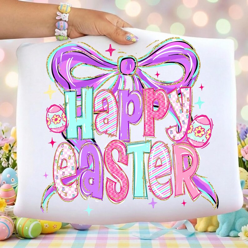 May include: White cushion featuring a colourful "Happy Easter" design. The design includes a large purple bow, the words "Happy Easter" in various colours, and Easter eggs with gold glitter accents.