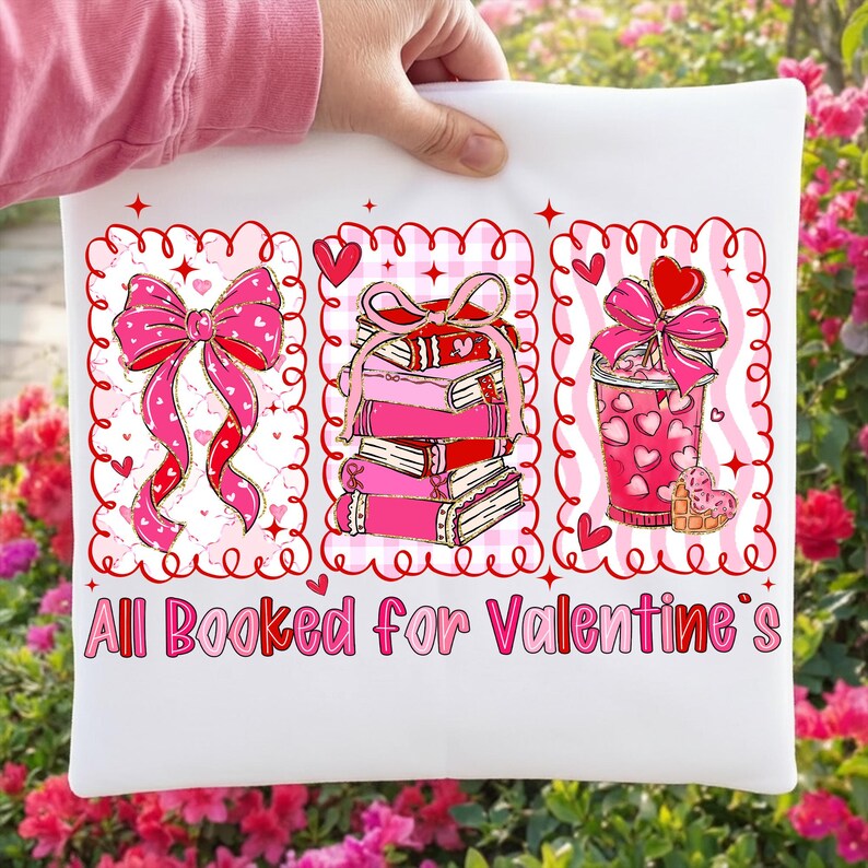 May include: White pillow with a Valentine's Day design. The design includes a pink bow, a stack of pink books, and a pink drink with a heart-shaped cookie. The text "All Booked for Valentine's" is printed in pink.