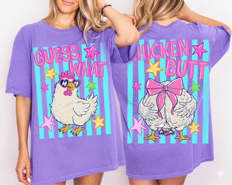 May include: A purple t-shirt with a graphic design featuring a cartoon chicken wearing sunglasses and the text "GUESS WHAT" on the front. The back of the shirt has a chicken butt graphic and the text "CHICKEN BUTT".