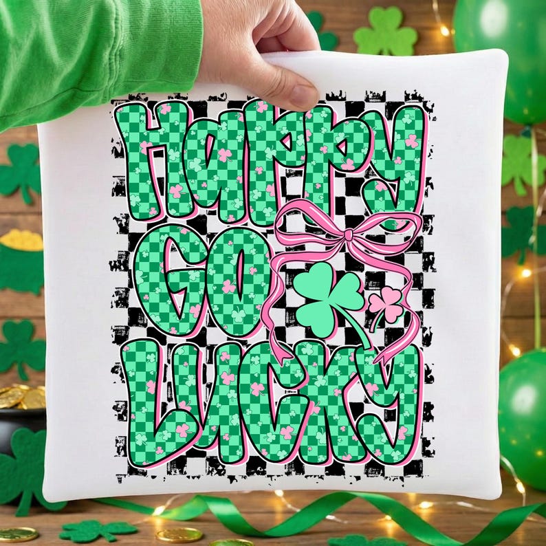 May include: White square pillow with the text "Happy Go Lucky" in green and pink, with a checkered background. The design includes a pink bow and shamrocks, perfect for St. Patrick's Day.
