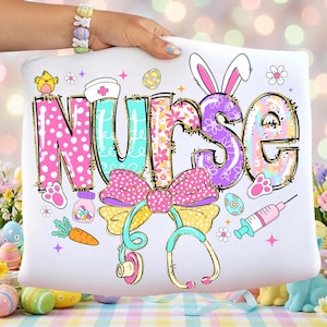 May include: White pillow with the word "NURSE" in colorful, decorative lettering. The design includes Easter-themed elements like bunny ears, eggs, a bow, a stethoscope, and a syringe. The pillow is held by a person.