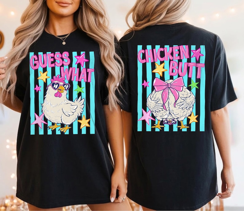 May include: Black t-shirt with a whimsical design featuring a cartoon chicken wearing sunglasses and the text "GUESS WHAT" on the front. The back of the shirt displays a chicken's rear with a pink bow and the words "CHICKEN BUTT".