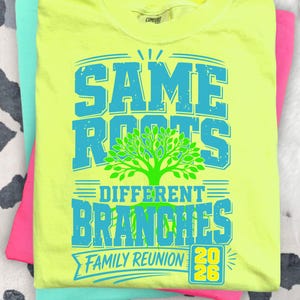 May include: A neon yellow t-shirt featuring the text "SAME ROOTS DIFFERENT BRANCHES FAMILY REUNION 2026" in turquoise and green, with a tree graphic. The shirt is folded on top of other brightly coloured shirts.