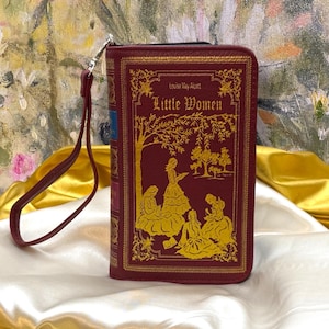 Little Women book wallet front cover shown as a book-style clutch with detachable wristlet strap