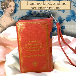 Back view of Jane Eyre book wallet displayed on ivory satin, featuring quote, and full printed design and wristlet placement