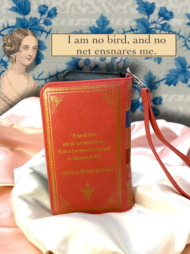 Back view of Jane Eyre book wallet displayed on ivory satin, featuring quote, and full printed design and wristlet placement