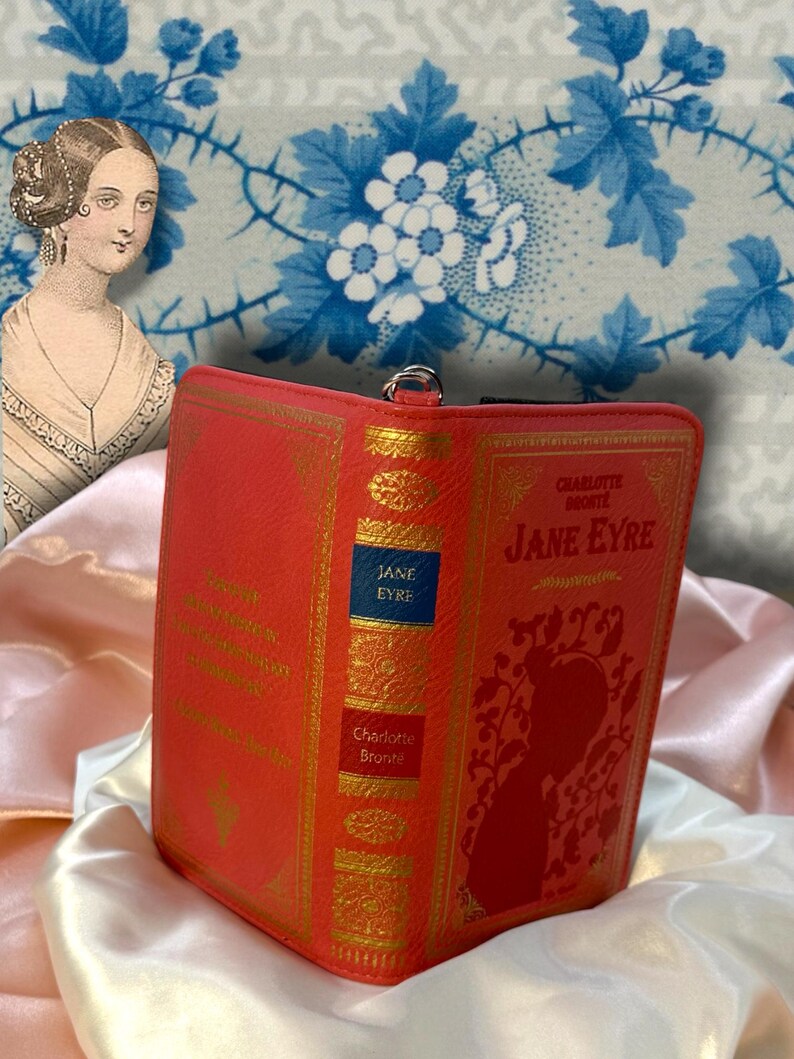 Jane Eyre book wallet opened like a book on ivory satin, displaying front and back covers with visible spine structure