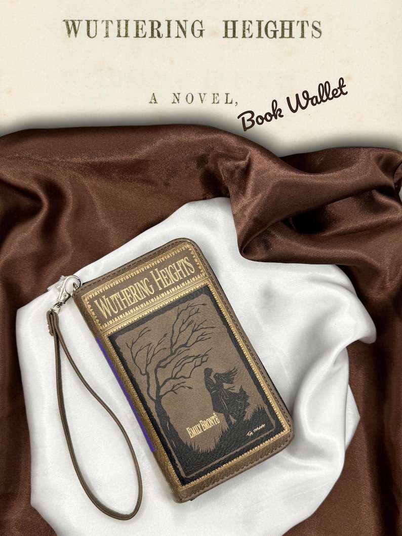 Wuthering Heights book wallet laying flat on ivory satin with front cover facing up, highlighting full cover artwork and moody color tones