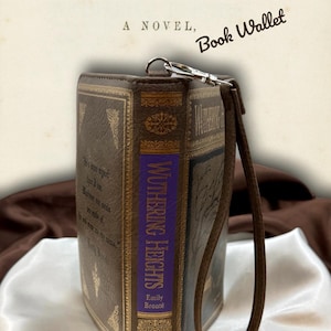 Wuthering Heights wallet opened like a book on ivory satin, displaying front and back covers with visible spine structure
