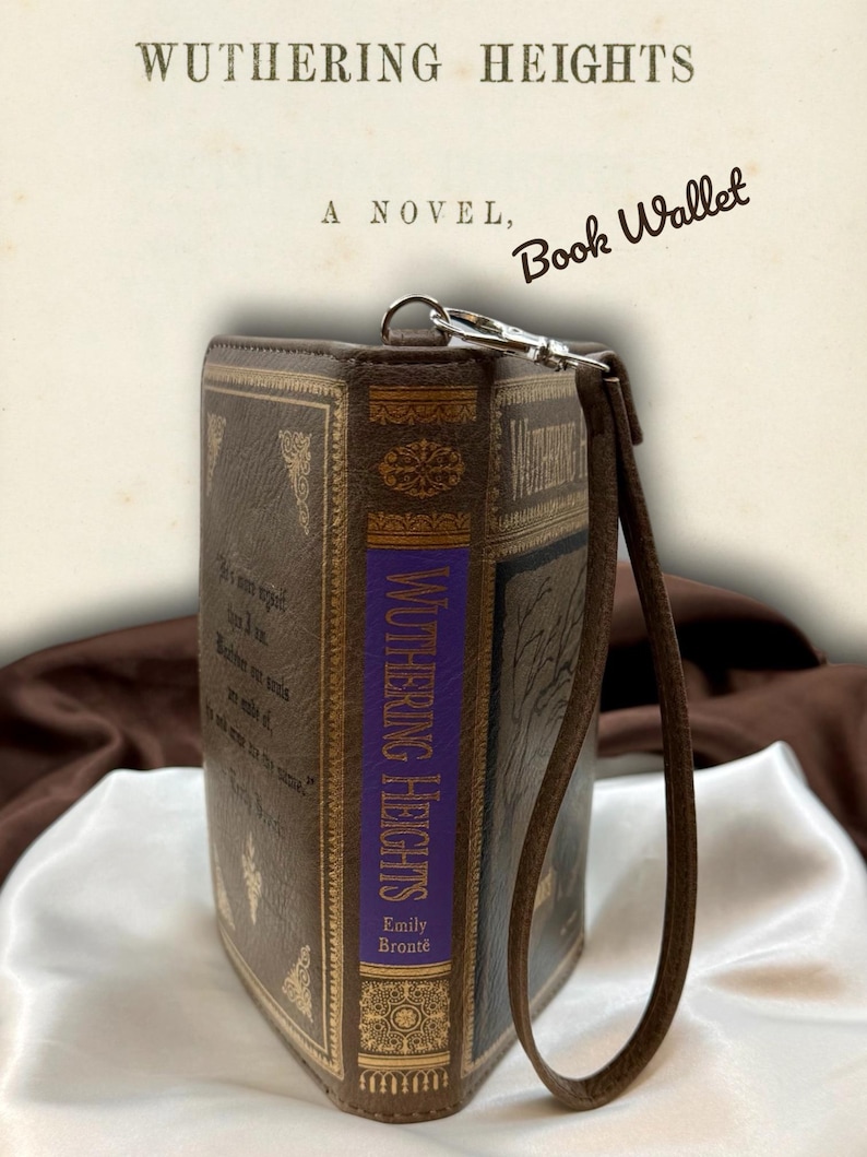 Wuthering Heights wallet opened like a book on ivory satin, displaying front and back covers with visible spine structure