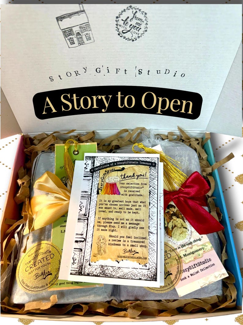 StoryGiftStudio order packaged in gift box with book wallets wrapped in organza bags, satin ribbon ties, and certificate of a StoryGiftStudio treasure placed on top