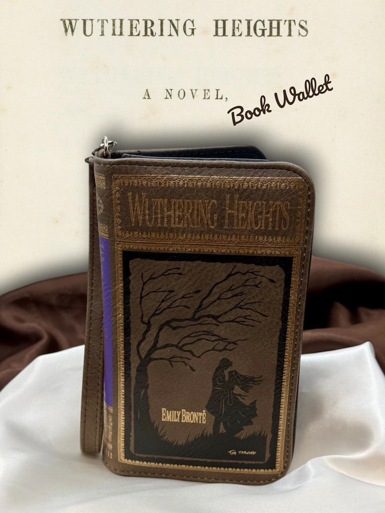 Wuthering Heights book wallet standing upright on ivory satin fabric with soft folds, showing the moody front cover design and structured book shape