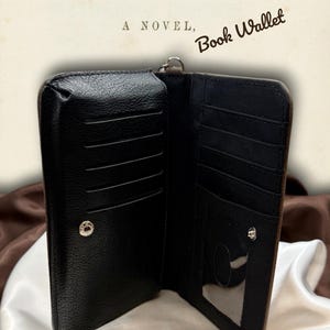 Interior of Wuthering Heights book wallet shown open, revealing card slots, ID window, and organized compartments with black fabric lining