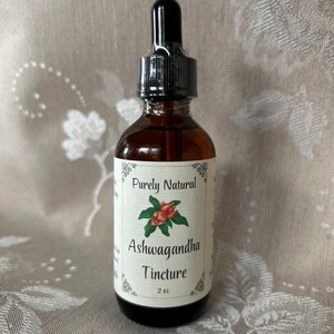 K&ouml;nnte beinhalten: Eine 2 oz Flasche Purely Natural Ashwagandha Tinktur. Die Flasche hat einen schwarzen Tropfer und ein wei&szlig;es Etikett mit einer roten und gr&uuml;nen Illustration einer Ashwagandha-Pflanze.