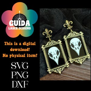 May include: Gold-coloured earrings with a black background, each displaying a white bird skull within a decorative frame. The earrings are topped with a fleur-de-lis. The image includes text: "This is a digital download! No physical item! SVG PNG DXF."
