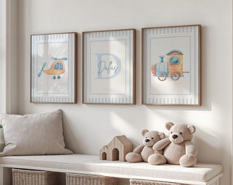 May include: Three framed prints with blue and white striped borders. The prints feature a helicopter, the letter D with the name Dallas, and a train. The prints are displayed on a white wall above a wooden bench.
