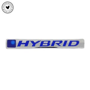 May include: A chrome "HYBRID" badge with blue lettering and a blue circle on the left. The rectangular badge has a reflective surface. A "HANDMADE WITH LOVE" logo is in the upper left corner.