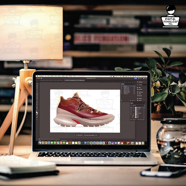 May include: A laptop displays a digital design of a maroon and tan athletic shoe. The shoe has a unique design with a chunky sole and intricate lacing. The screen also shows the Adobe Photoshop interface, suggesting the shoe is being designed.