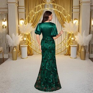 Luxury satin evening gown featuring a flattering V neck, half sleeves, shimmering sequin details and a fitted waist. This elegant maxi dress is ideal for wedding guests, formal parties, receptions, proms and elegant celebrations.