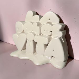 May include: A set of three ceramic mugs with a speckled, matte finish. The mugs are in shades of cream, light grey, and dark grey. Each mug has a simple, minimalist design, ideal for coffee or tea.