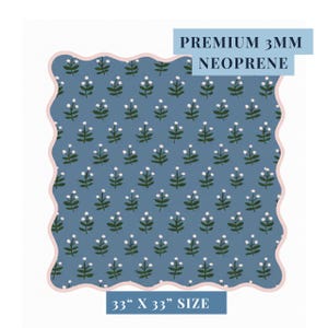 May include: A blue neoprene fabric with a floral pattern. The fabric has a scalloped edge with a pink border. The text "PREMIUM 3MM NEOPRENE" and "33" X 33" SIZE" are printed on the fabric.