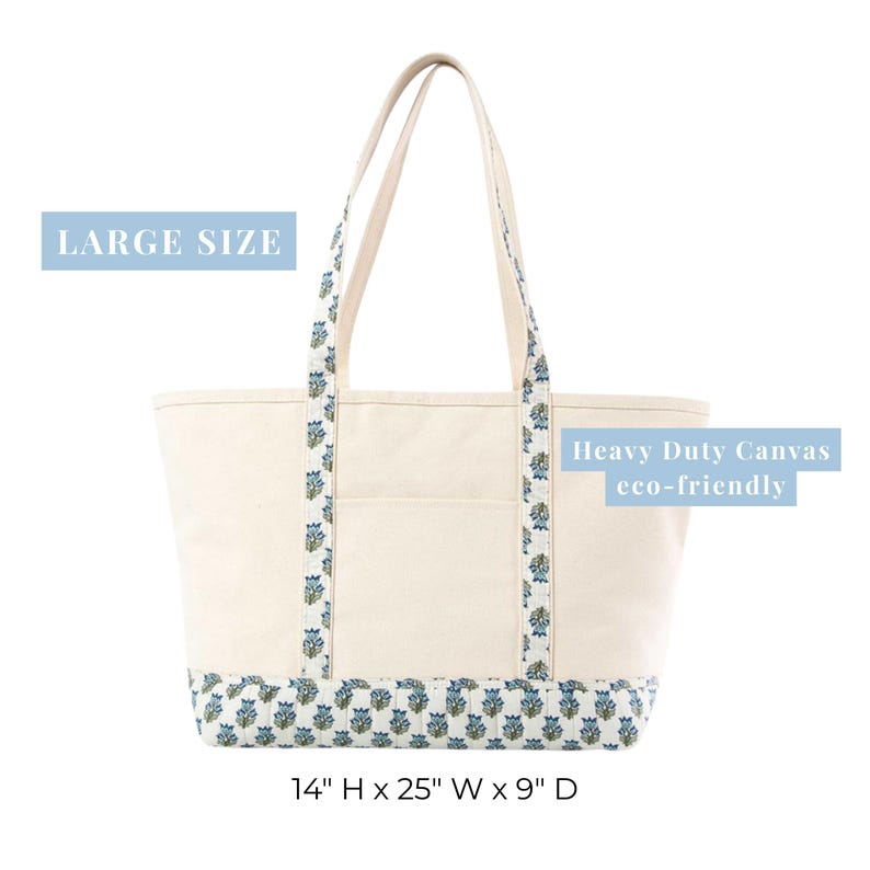 May include: Cream canvas tote bag with blue floral detailing. The bag has a large size, sturdy handles, and a floral patterned base. The text "Heavy Duty Canvas eco-friendly" is visible. Dimensions are 35.5cm H x 63.5cm W x 23cm D.