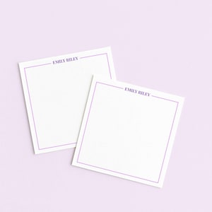 May include: Two white square notepads with a lavender border and the name "EMILY RILEY" printed at the top. The notepads are on a light purple background.