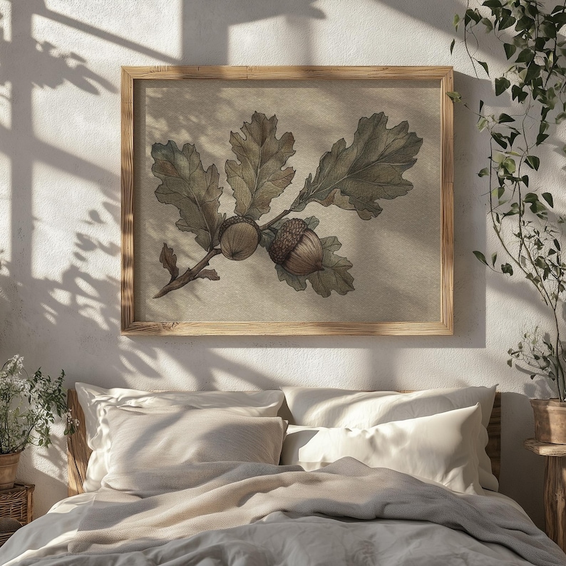 May include: A framed botanical print featuring an oak branch with leaves and acorns. The artwork is rendered in muted green and brown tones, set against a neutral background. The frame is made of light-colored wood, adding a natural touch to the decor.