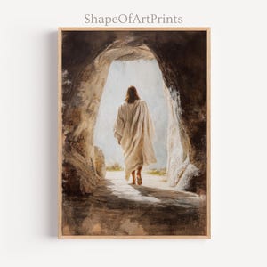 May include: A framed print depicting a figure in a white robe exiting a stone cave. The artwork has a vintage, painterly style with warm, earthy tones. The text "ShapeOfArtPrints" is at the top.