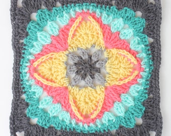 May include: A square crochet motif featuring a central dark gray star-like pattern surrounded by layers of yellow, coral pink, and turquoise yarn. The outer border is composed of dark gray stitches, creating a geometric floral design.
