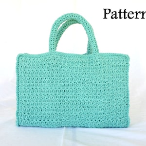May include: A light blue crocheted tote bag with a simple stitch pattern. The bag has two handles and a rectangular shape.