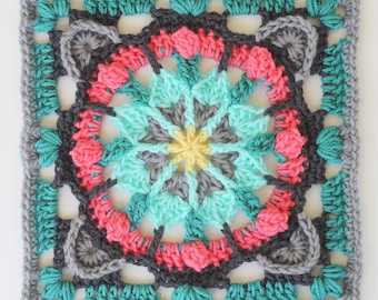 May include: A square crochet motif featuring a central yellow star, surrounded by layers of teal, gray, and bright pink yarn. The intricate pattern transitions from a circular floral design in the center to a square border in gray.