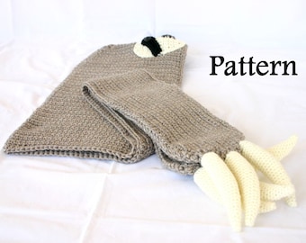 May include: Crocheted sloth pattern with a brown body, white claws, and black eyes. The pattern is laid out flat on a white surface. The word "Pattern" is written in black text on the right side of the image.