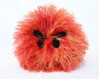 Stuffed toy orange red crochet puff ball large angry face soft plush faux fur round fluffy squishy creature named Magma not for children