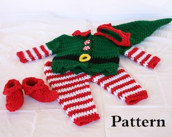 May include: A crocheted elf costume for a baby, featuring a green and black elf hat, a green and white striped shirt, red and white striped trousers, and red booties. The pattern is included.