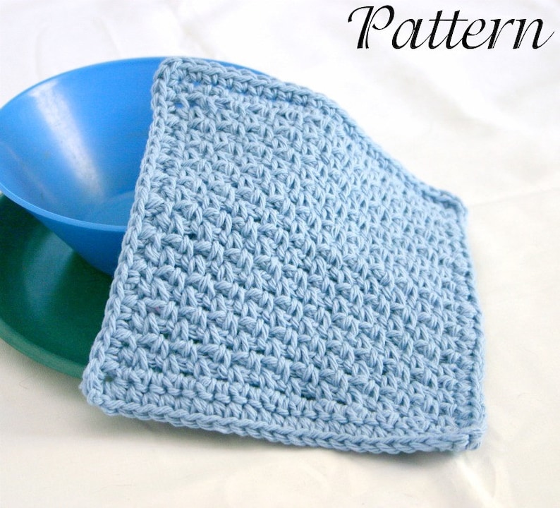 May include: A light blue crochet dishcloth or kitchen scrubber. The cloth is made with a simple stitch pattern and is folded in half.