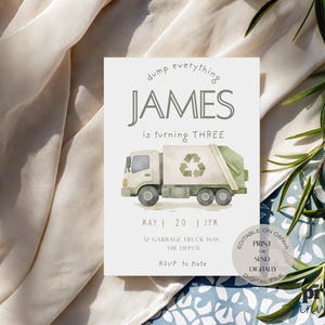 May include: A birthday invitation featuring a watercolor illustration of a garbage truck with a recycling symbol. The text reads "dump everything JAMES is turning THREE" with the date and time below. The invitation is on a white background.