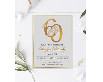 May include: A gold and white invitation card with a floral design and the number 60. The text on the card reads "Please join us to celebrate Sandy's Birthday, March 15th from 8pm, 123 Anywhere St., Any City, RSVP: Sandy 123-456-7890".