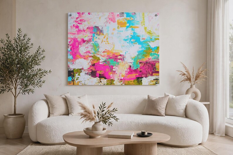 May include: A large rectangular wall art piece featuring an abstract composition with vibrant splashes of hot pink, bright turquoise, sunny yellow, and white paint. The artwork displays thick, textured brushstrokes and layered color blocks.