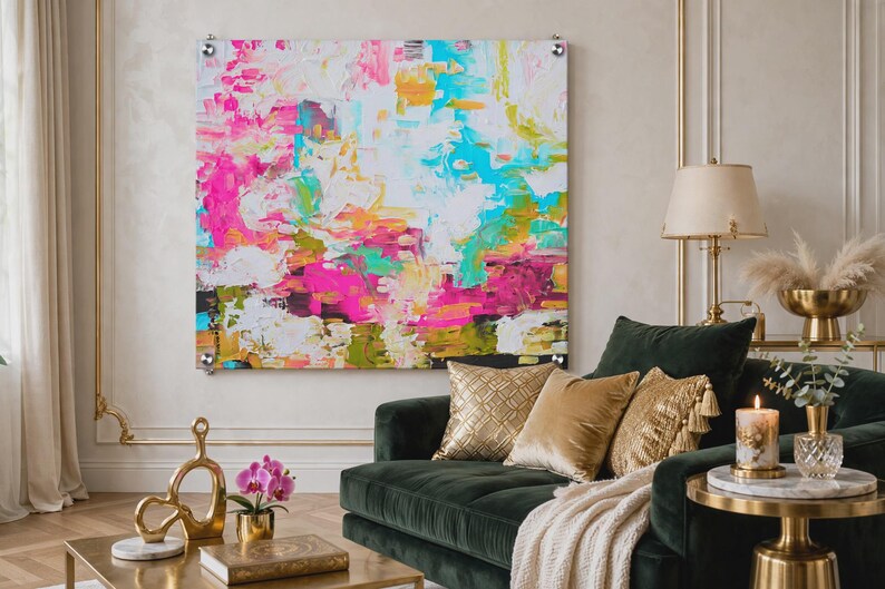 May include: A large square abstract painting featuring thick, textured brushstrokes in vibrant shades of hot pink, turquoise, bright yellow, and white. The artwork is mounted on the wall with four silver metal standoffs at each corner.