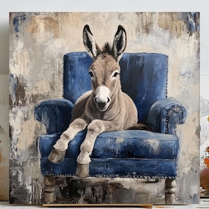 May include: An oil painting of a donkey relaxing in a blue armchair. The donkey has grey fur and a white muzzle. The armchair is a deep blue with button detailing. The background features neutral tones of beige and grey, creating a rustic feel.