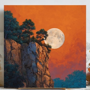 May include: An art print shows a landscape with a full moon in an orange sky. A rocky cliff with green trees is in the foreground. The cliff face has textured details in shades of brown and tan, creating a sense of depth.