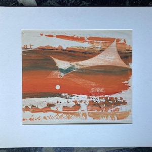 May include: Abstract painting with a landscape theme. The artwork features a vibrant palette of orange, brown, and white, with a prominent white shape and a small white circle. The painting is mounted on a white mat.