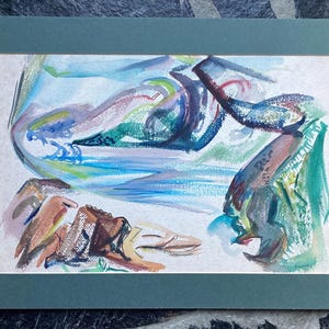 May include: Abstract watercolor painting in a teal mat. The artwork features a landscape with blue, green, brown, and purple hues. The painting has a flowing, dynamic composition with soft edges and a textured appearance.