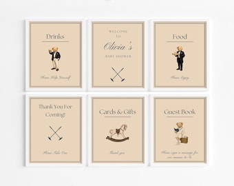 May include: Set of six framed signs with a beige background and white borders. The signs include text such as "Drinks", "Food", and "Guest Book", along with illustrations of a teddy bear and polo symbols. The signs are for a baby shower.