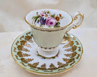 Juego de taza de té y platillo perfectamente desiguales con flores verdes y doradas de Foley y Stanley