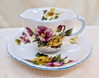 Juego de taza de té y platillo vintage SHELLEY con delicadas begonias rosa y amarillas, ribete azul, Inglaterra
