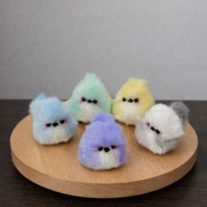 May include: A white ceramic mug with a black handle and the text "But First, Coffee" in a black, handwritten-style font. The mug is on a white surface.