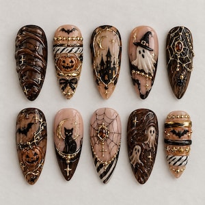 May include: A set of ten almond-shaped press-on nails featuring intricate Halloween designs in black, gold, and beige. The nails display motifs including ghosts, pumpkins, black cats, bats, haunted houses, spider webs, and stars with 3D-like details.